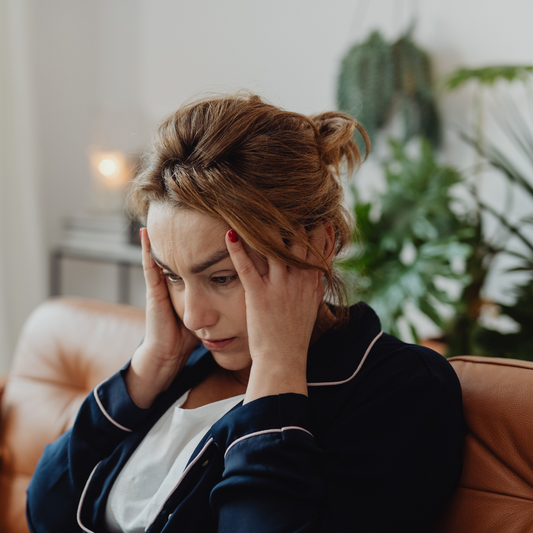 Woman holding her head in pain