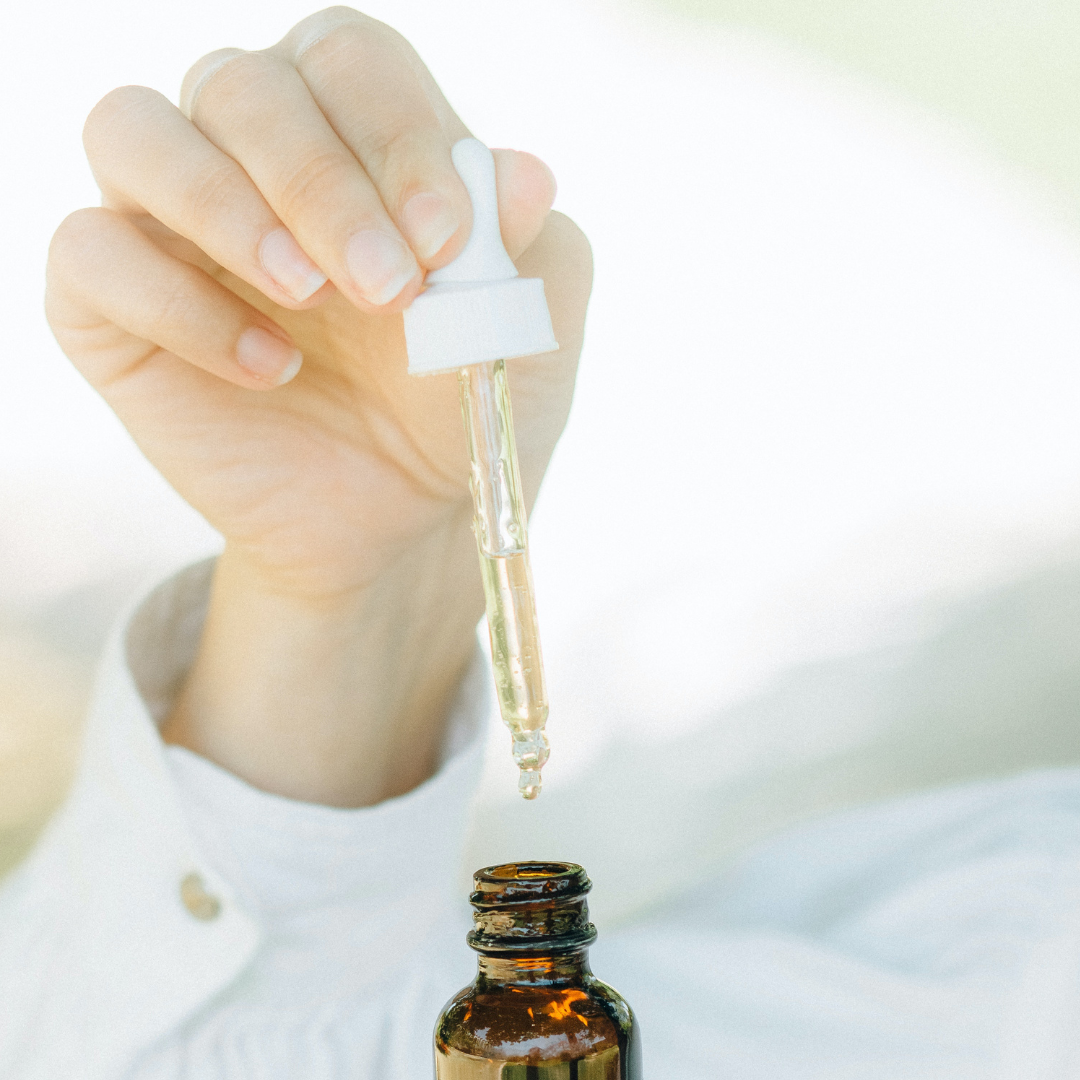 woman holding CBD oil 